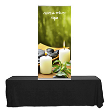Blade Lite 36 tabletop banner stand on a table with rollup graphic.