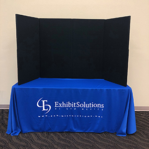 Folding panel trade show tabletop display with black velcro compatible fabric.
