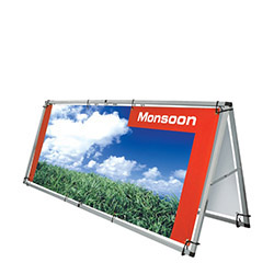 Monsoon outdoor banner stand with silver frame and vibrant graphic banner.