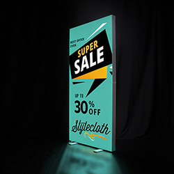 SEG backlit portable banner stand with LED lights and vibrant fabric graphic.
