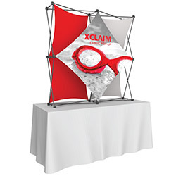 Xclaim pop-up fabric tabletop display with variious graphics